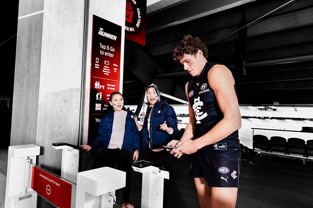 Footy Player with mobile phone entering the stadium